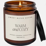 Sweet Water Decor Warm Cozy Soy Candle - Orange Peel, Tan Label, Amber. Fixed Price $26.99.